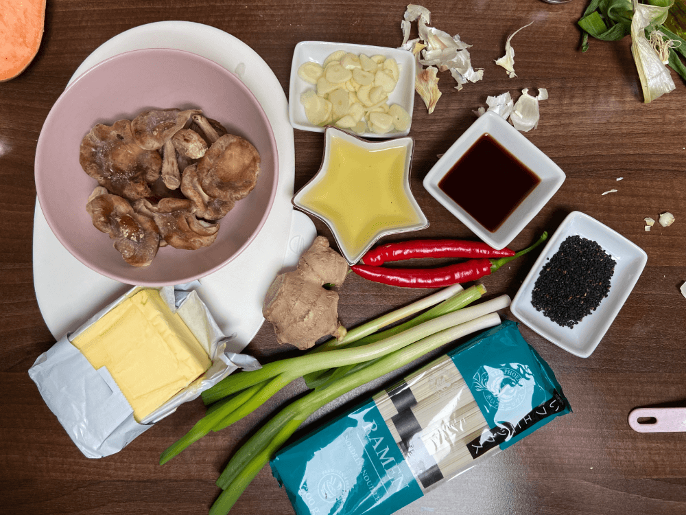 Vegetarian ramen noodles soup recipe - shiitake mushroom, sliced garlic, butter , ramen noodles, soya souce, red pepper, green onions, ginger