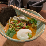 Vegetarian Noodles Soup in a Bowl with egg, pok choy, green onions, noshi